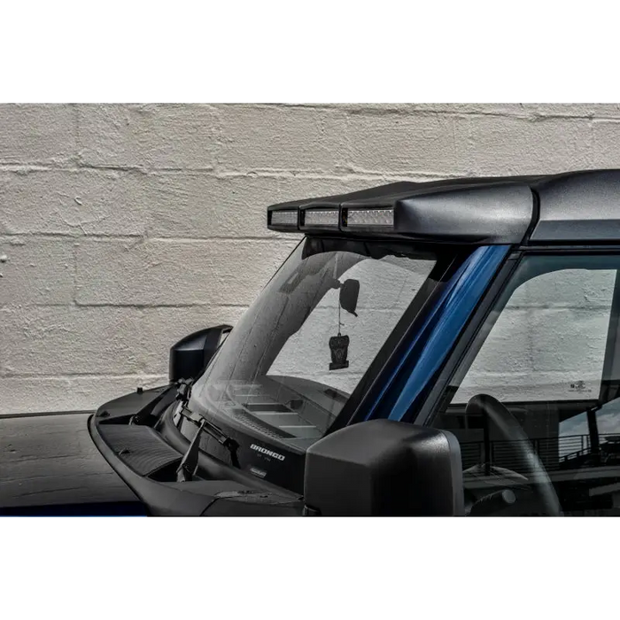 Black car with blue roof, black window - Oracle 2021+ Ford Bronco Integrated Windshield Roof LED Light Bar System.