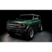 Green lifted truck with black bumper featuring Oracle’s 2021+ Ford Bronco Integrated Windshield Roof LED Light Bar System.