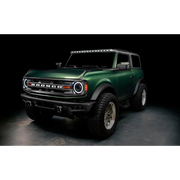 Green lifted truck with black bumper featuring Oracle 2021+ Ford Bronco Integrated Windshield Roof LED Light Bar System