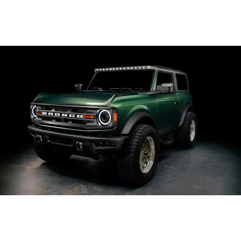 Green lifted truck with black bumper featuring Oracle 2021+ Ford Bronco Integrated Windshield Roof LED Light Bar System