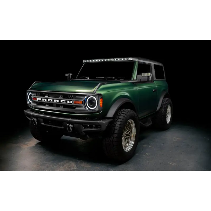 Green lifted truck with black bumper featuring Oracle 2021+ Ford Bronco Integrated Windshield Roof LED Light Bar System