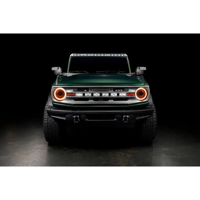 Green Jeep with black background next to Oracle 2021+ Ford Bronco Oculus Bi-LED Projector Headlights.