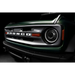 Front end of a green Jeep with Oracle 2021+ Ford Bronco Oculus Bi-LED Projector Headlights - Amber/White Switchback on black background