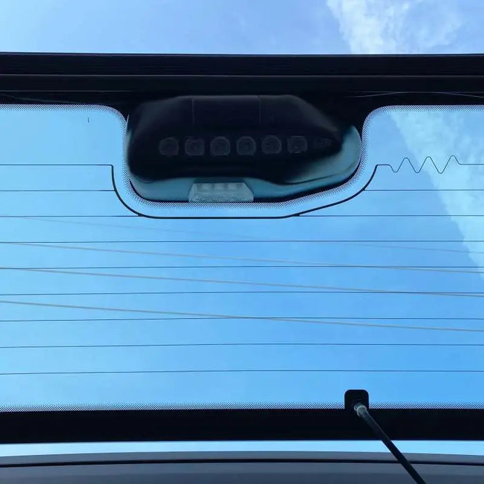 Rear window view of Ford Bronco cargo light module with blue sky background