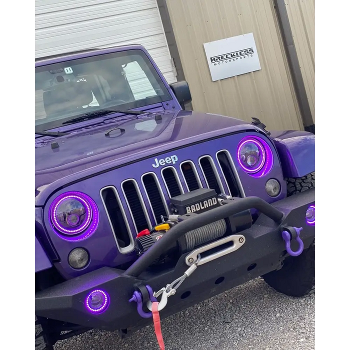 Oracle 7in high powered LED headlights on purple Jeep in front of building