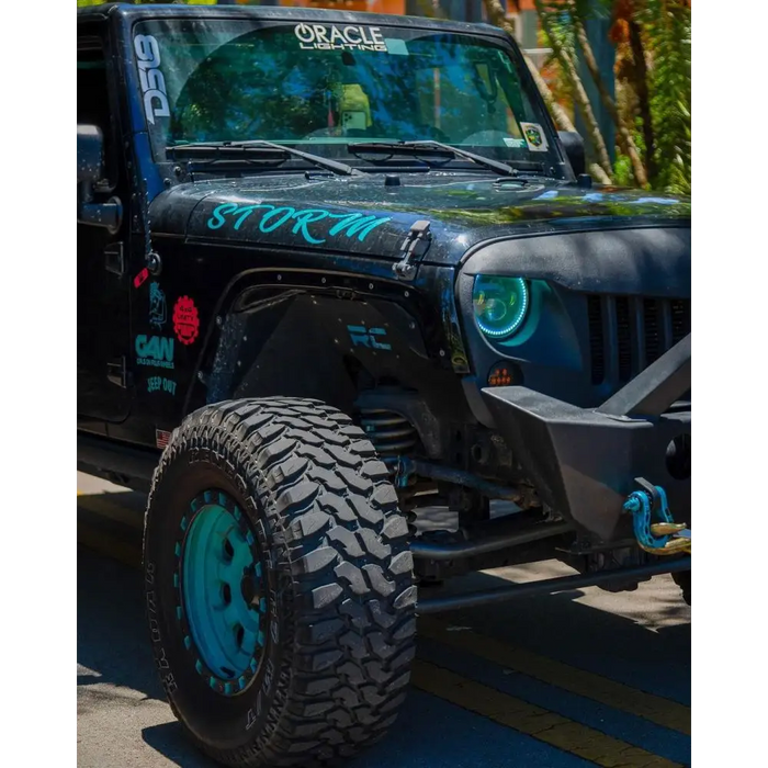 Jeep with blue and black decal featuring Oracle 7in High Powered LED Headlights - Black Bezel - ColorSHIFT 2.0