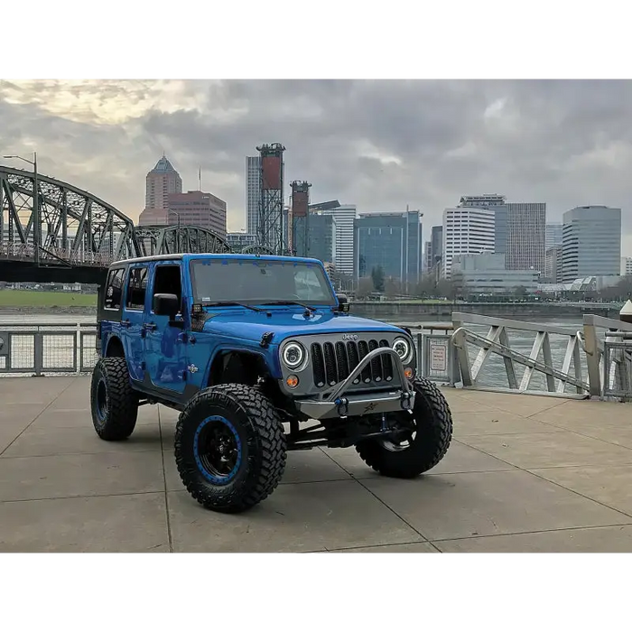 Blue jeep featuring Oracle 7in High Powered LED Headlights with a big tire on the front