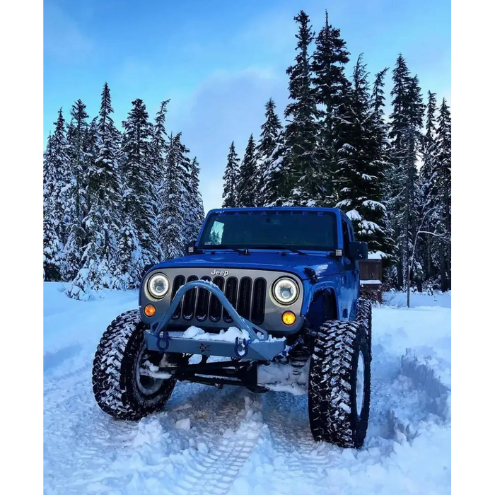 Oracle ColorSHIFT LED headlights on blue jeep in snow.