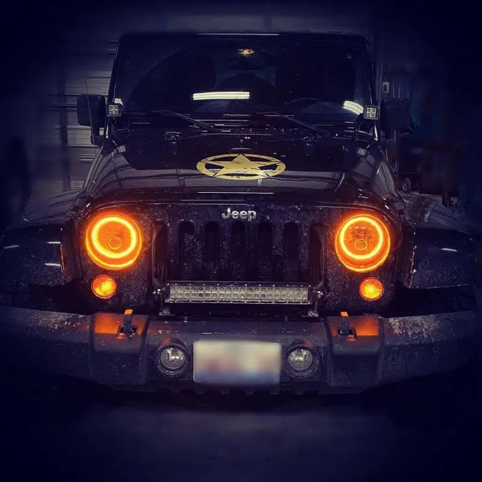 Oracle ColorSHIFT LED Headlights illuminating yellow light on Jeep Wrangler.