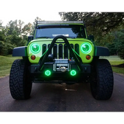 Customized Jeep Wrangler with Green LED Lights on a Black Bezel Oracle 7in High Powered LED Headlights