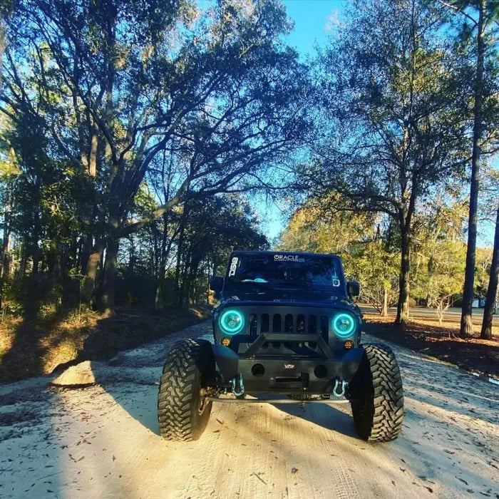 7in LED headlights on Jeep Wrangler driving down dusty road