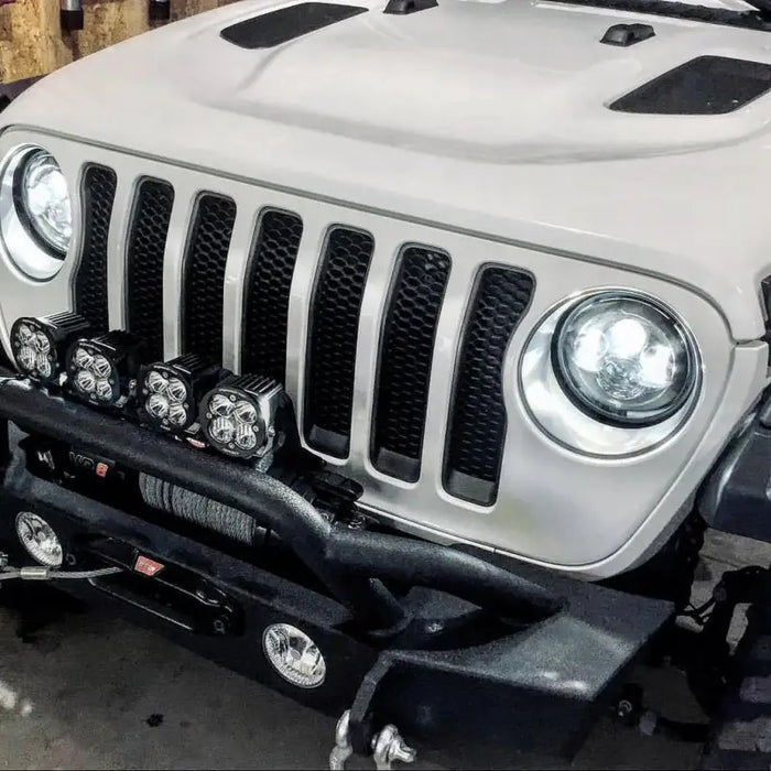 Close-up of Jeep with front bumper, illuminated by Oracle 7in High Powered LED Headlights - Black Bezel - ColorSHIFT.