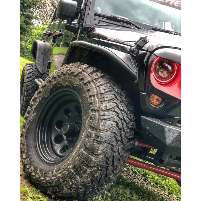 Black Oracle 7in LED Headlights on Dynamic Jeep in Grass