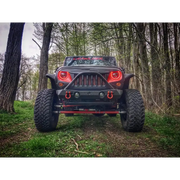 Oracle 7in High Powered LED Headlights - Black Bezel in a dynamic forest setting.