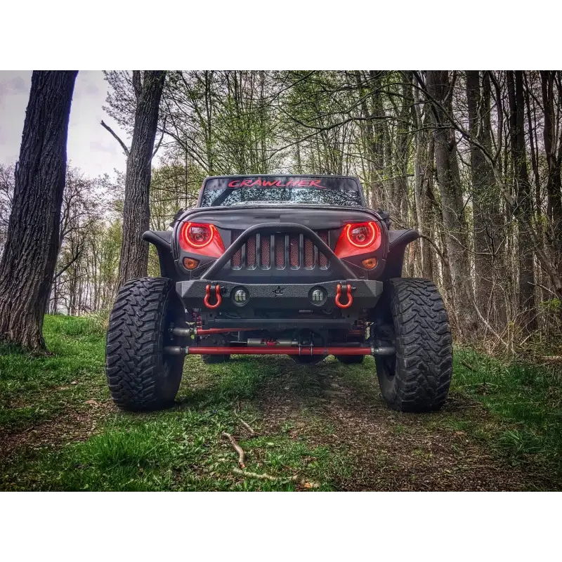Oracle 7in High Powered LED Headlights - Black Bezel in a dynamic forest setting.