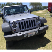 Gray Jeep parked in field with Oracle 7in Dynamic LED Headlights