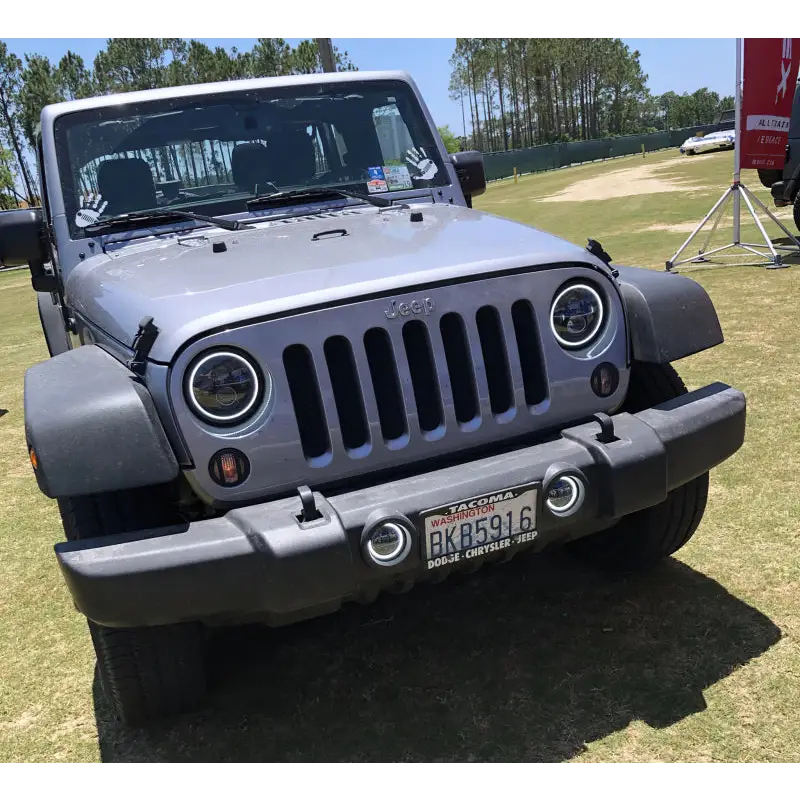Gray Jeep parked in field with Oracle 7in Dynamic LED Headlights