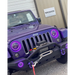 Dynamic purple LED headlights on a purple jeep parked in front of a building