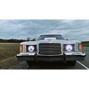 White car parked on road with Oracle 7in LED Headlights in black bezel.