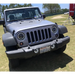 Gray Jeep parked in field with Oracle 7in High Powered LED Headlights in Black Bezel and White color.