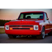 Red truck parked on road next to Oracle 7in LED headlights - black bezel - white