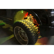 Black truck with yellow tire cover, part of Oracle Bluetooth + RF Underbody Rock Light Kit - 8 PCS - ColorSHIFT.
