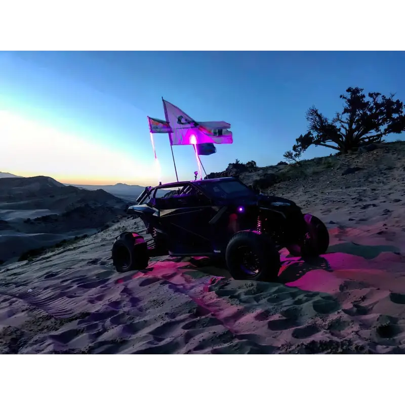 Black car with flag on top featuring Oracle Bluetooth + RF Underbody Rock Light Kit - 8 PCS - ColorSHIFT