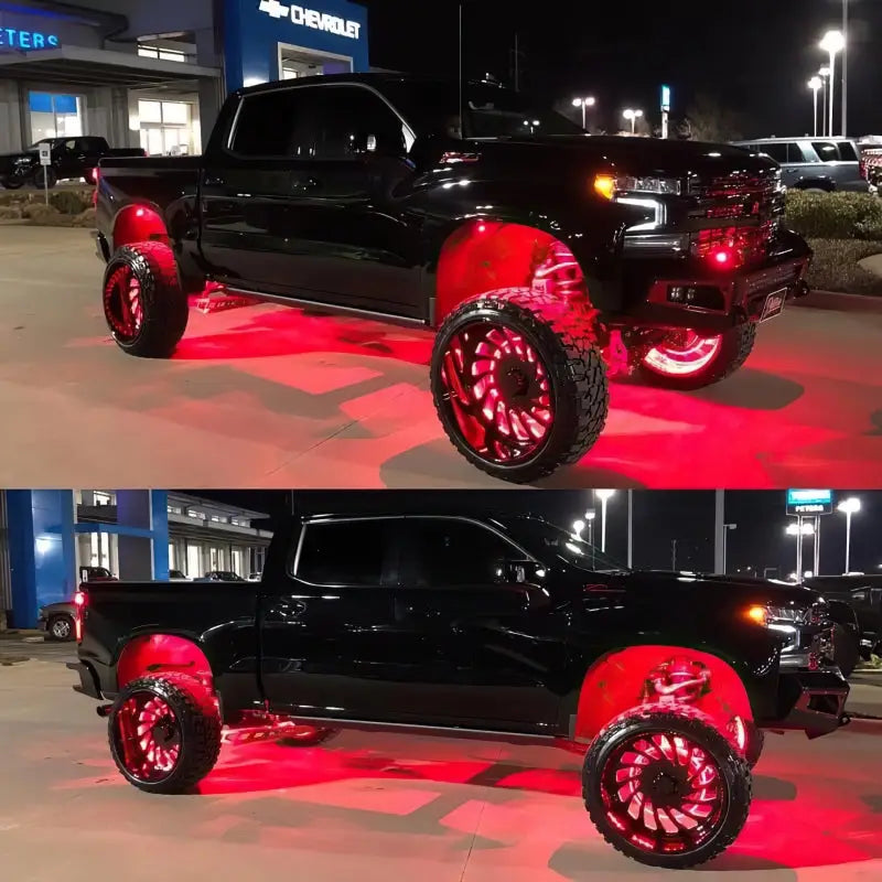 Black truck with red wheels and rims illuminated by an Oracle ColorSHIFT Underbody Rock Light Kit.