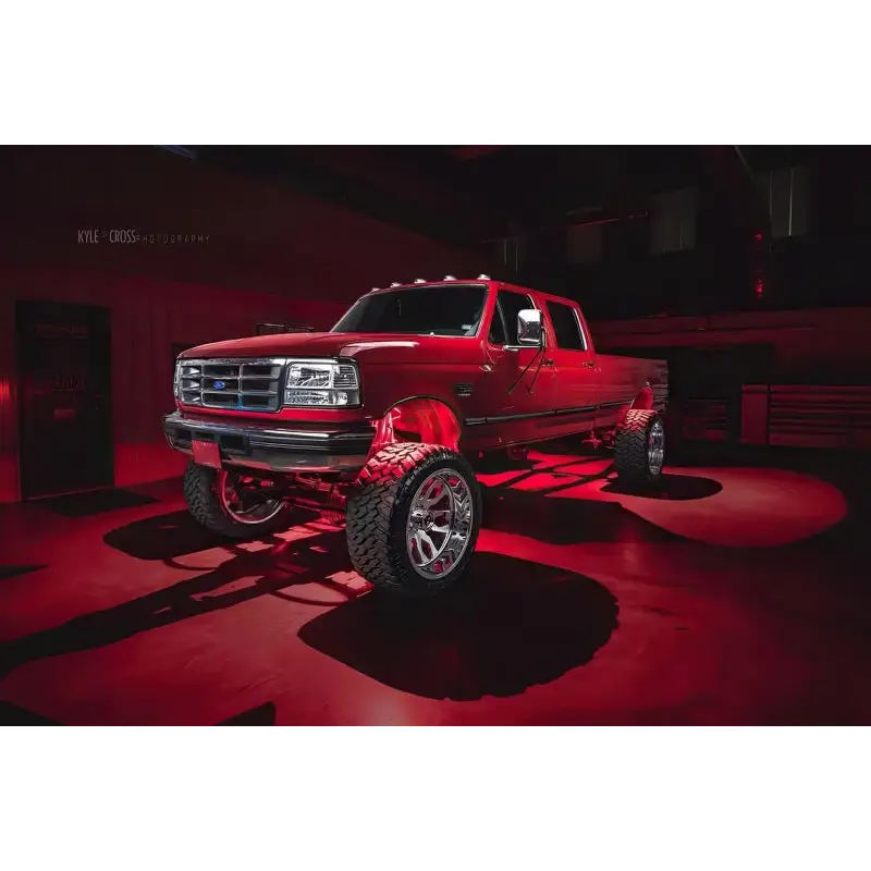 Red truck parked in garage with Oracle Bluetooth + RF Underbody Rock Light Kit - 8 PCS - ColorSHIFT.