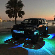 ColorSHIFT rock light kit on car with blue lights parked on road
