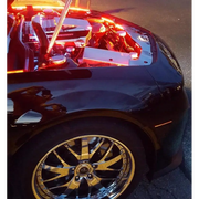 Black car with gold rims and red door illuminated by Oracle Engine Bay 5050 SMD Kit - RGB ColorSHIFT led strips