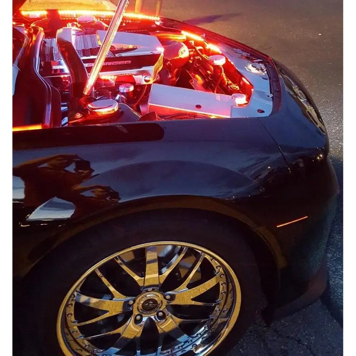 Black car with gold rims and red door illuminated by Oracle Engine Bay 5050 SMD Kit - RGB ColorSHIFT led strips