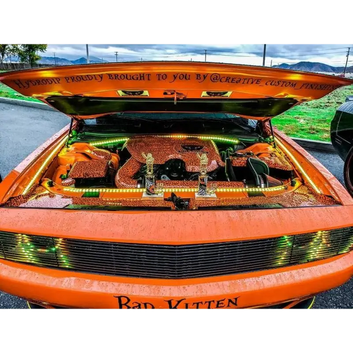 Close up of car with trunk full of Halloween decorations, featuring Oracle Engine Bay 5050 SMD Kit - RGB ColorSHIFT.