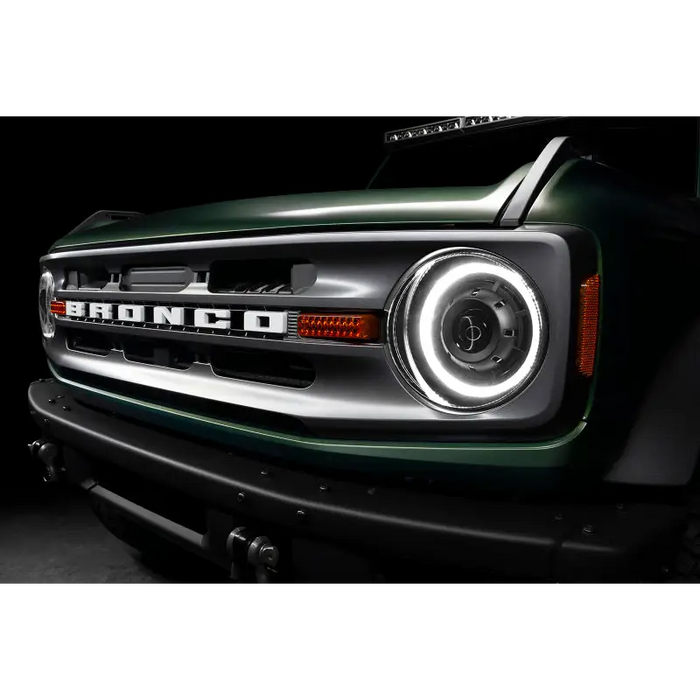 Green Jeep with black and white bumpers, Oracle Ford Bronco 21+ Oculus Bi-LED Projector Headlights.