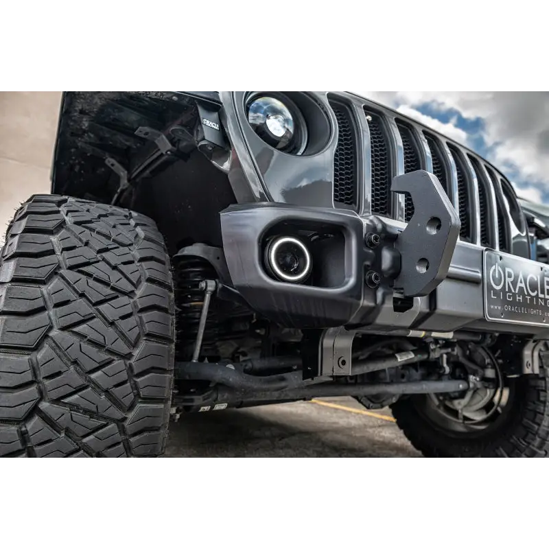 Close up of Oracle Jeep Wrangler JK/JL/JT High Performance W LED Fog Lights on road with big tire.