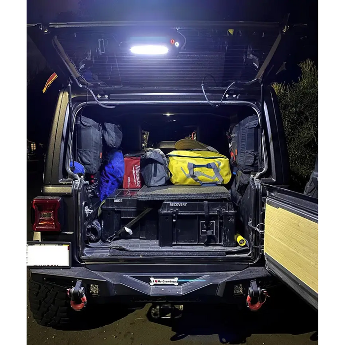 Truck with luggage in back showcasing Oracle Jeep Wrangler JL Cargo LED Light Module - Amber/White.