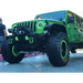Green Jeep Wrangler JL halo fog light kit with big tire.