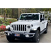 White Oracle Jeep Wrangler JL/Gladiator JT Sport with LED Fog Lights parked in front of house.