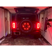Rear view of vehicle with Oracle LED Illuminated Wheel Ring 3rd Brake Light - Red