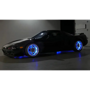 Wheel rings with blue lights on black car - Oracle LED Illuminated.