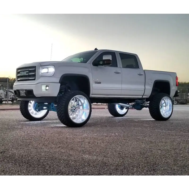 Silver truck with big tire featuring Oracle LED Illuminated Wheel Rings