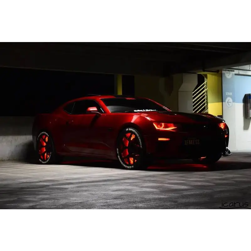 Red car in parking lot with Oracle LED Illuminated Wheel Rings - ColorSHIFT - 15in.