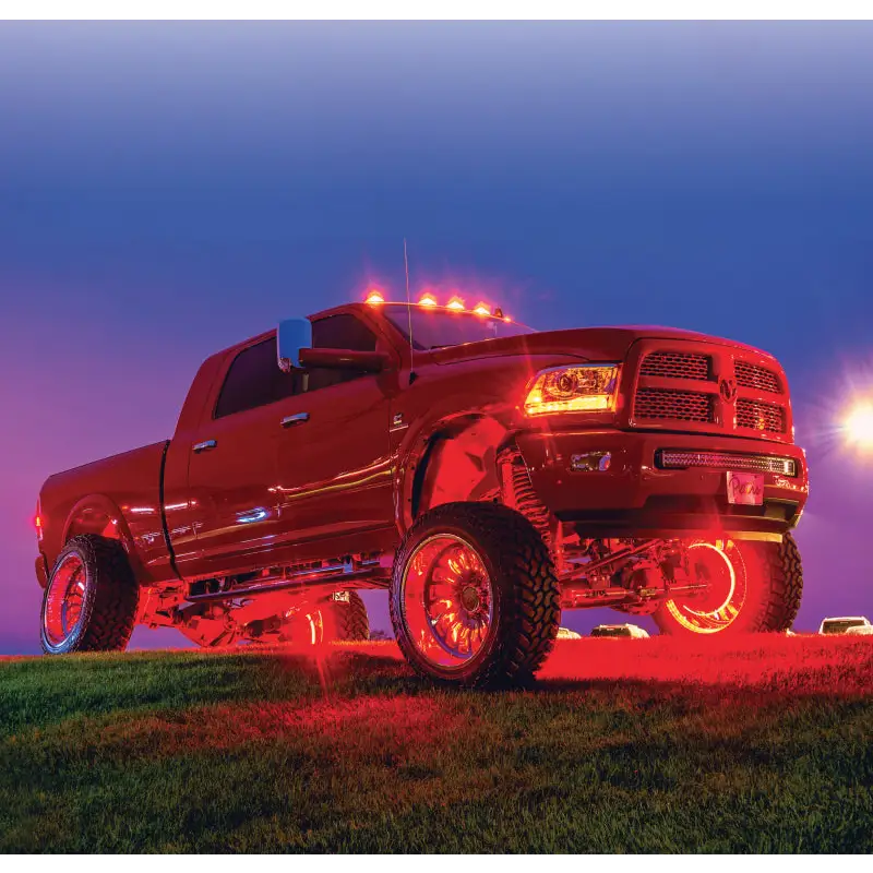 Red truck with illuminated wheel rings by Oracle LED.