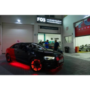 Black car parked in front of building with Oracle LED Illuminated Wheel Rings - ColorSHIFT.