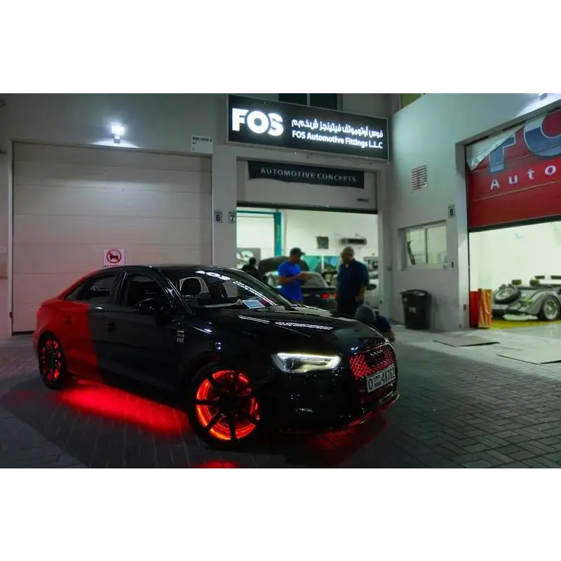 Black car parked in front of building with Oracle LED Illuminated Wheel Rings - ColorSHIFT.