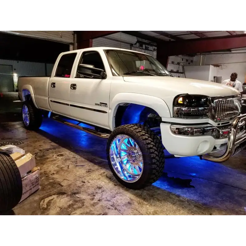 White truck with blue LED illuminated wheel rings by Oracle LED Illuminated - ColorSHIFT.