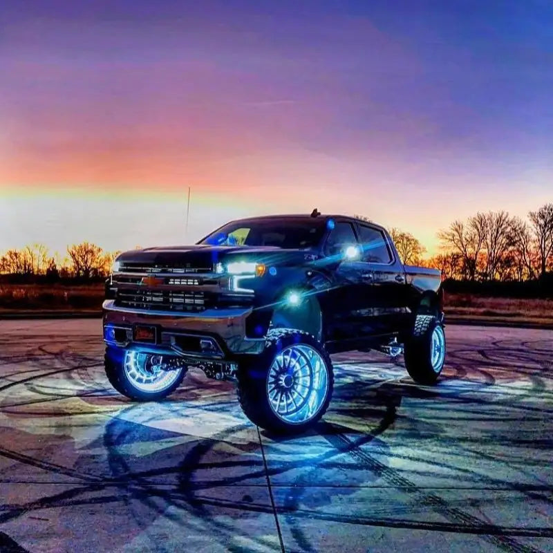 Black truck with bright blue wheels featuring Oracle LED Illuminated Wheel Rings - ColorSHIFT Dynamic.