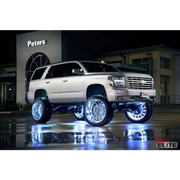 White Chevy Suburban with chrome rims and wheels featuring Oracle LED Illuminated Wheel Rings - ColorSHIFT.