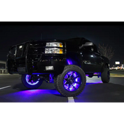 Black truck with purple LEDs illuminated wheel rings.