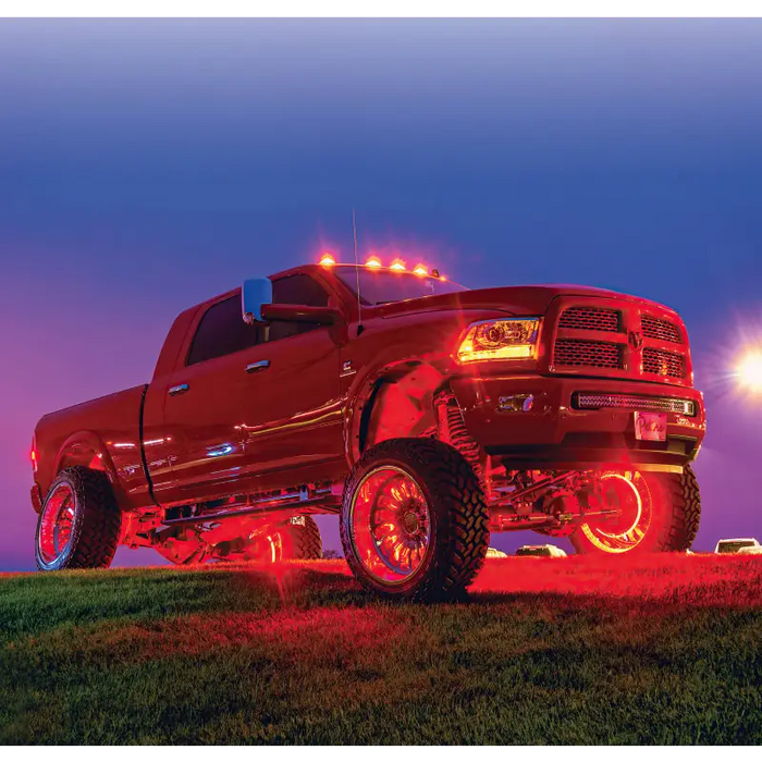 Red LED wheel ring kit on a truck with lights.